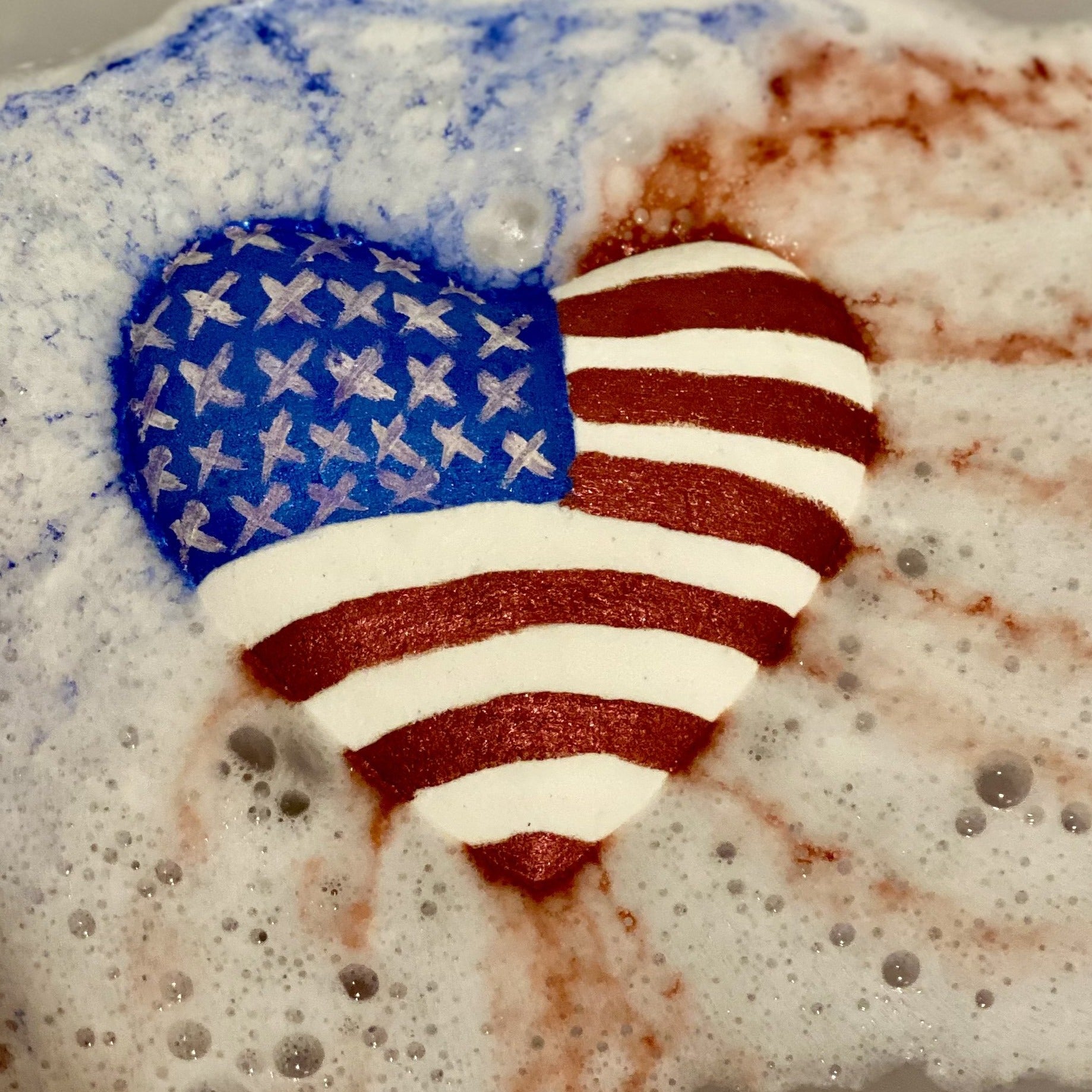 Big beautiful heart bath bomb with the American flag painted on it. 