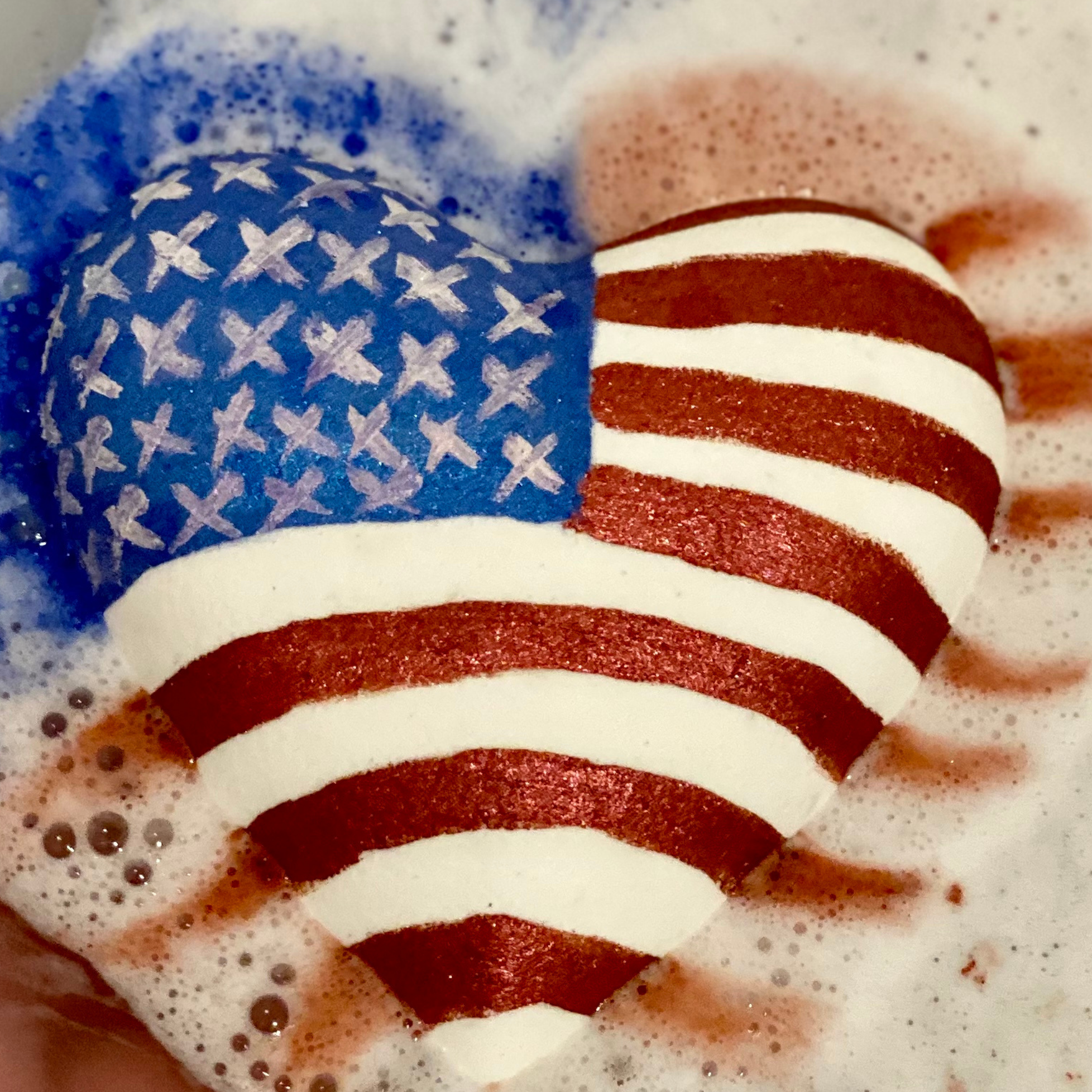 Big beautiful heart bath bomb with the American flag painted on it. 